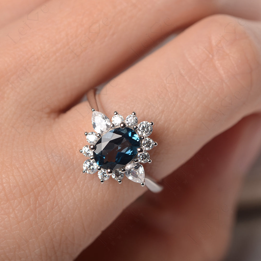 Oval Cut London Blue Topaz Ring With Pear Side Stone